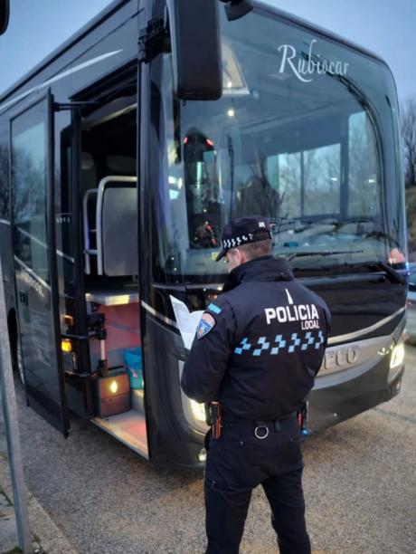 Agentes de la Policía Local durante un control de transporte escolar en Cuenca, verificando cinturones, documentación y medidas de seguridad para proteger a los menores.