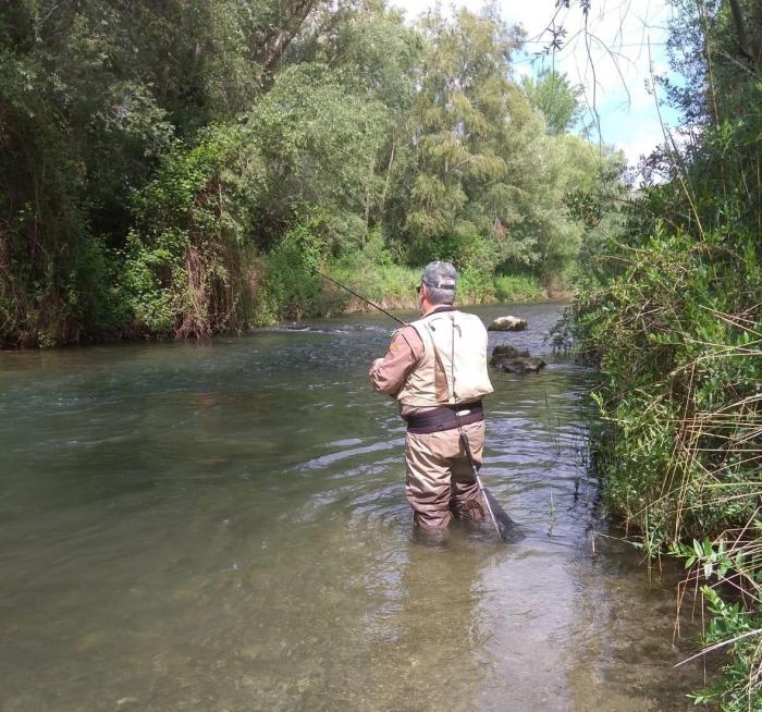 Pescador en un río |  Imagen de archivo